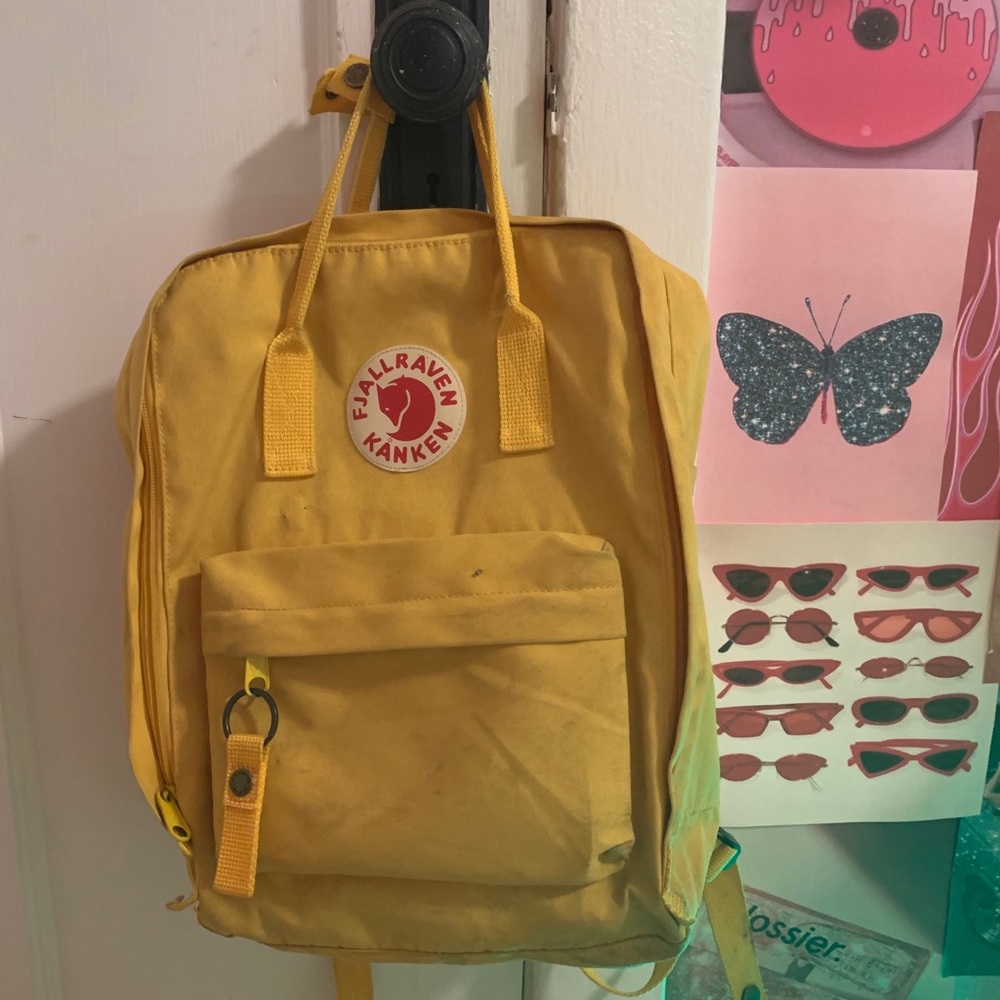 Yellow Fjallraven Kanken backpack.